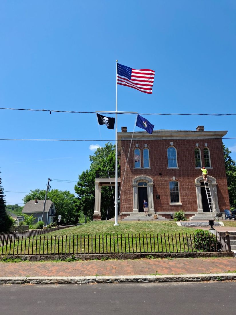 Nor’East Flagpole servicing a yardarm flagpole at a brick municipal building