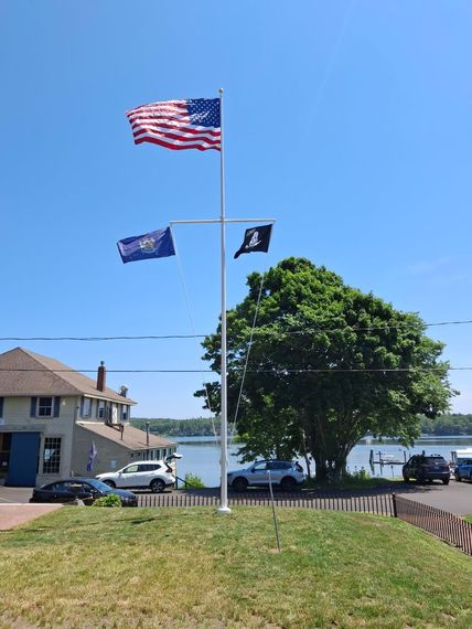 Yardarm flagpole with American, state and POW/MIA flags on the waterfront